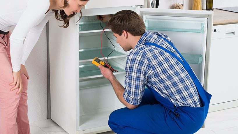 Technician checking a refrigerator
